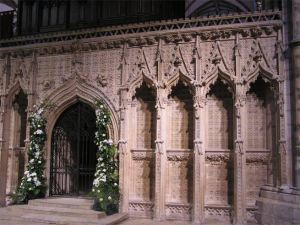 Ornate carved screen with lilies around gate