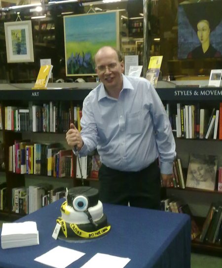 Richard Reynolds cutting cake with Crime Scene tape icing