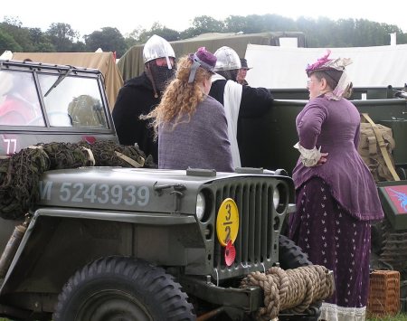 All characters gathered beside a jeep