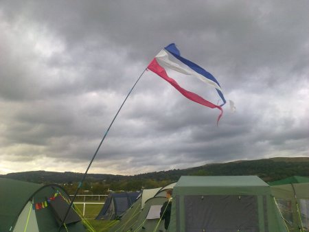 Picture of red white and blue pennants flying over tents
